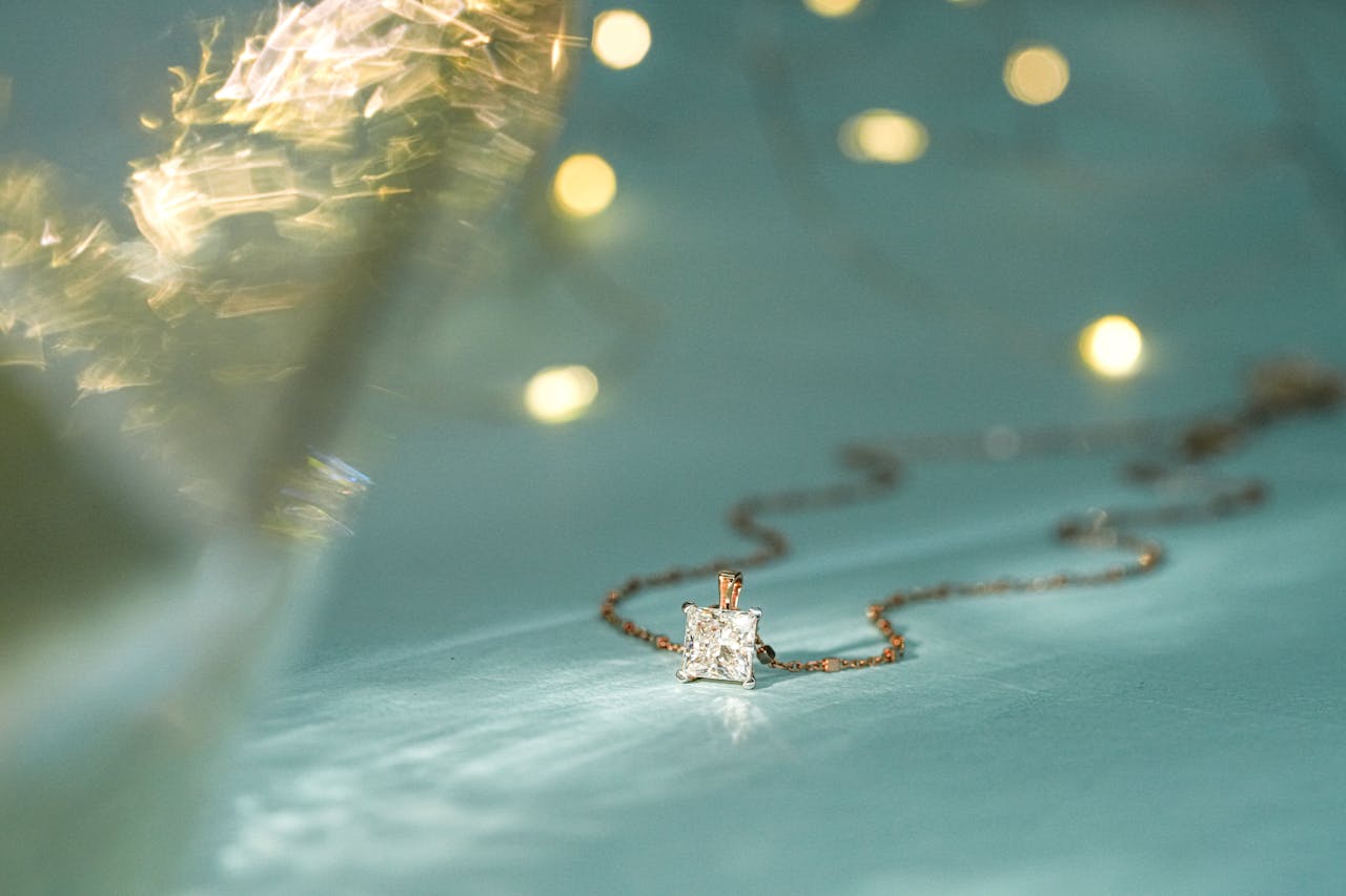 gallery-01 Close-up of a sparkling diamond pendant on a delicate chain, perfect for festive occasions.